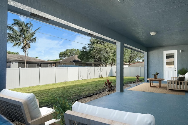 view of patio featuring an outdoor living space, a fenced backyard, and a wooden deck