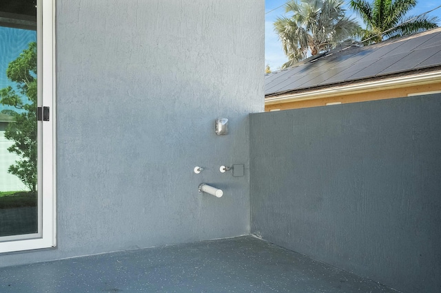 view of property exterior with stucco siding and solar panels