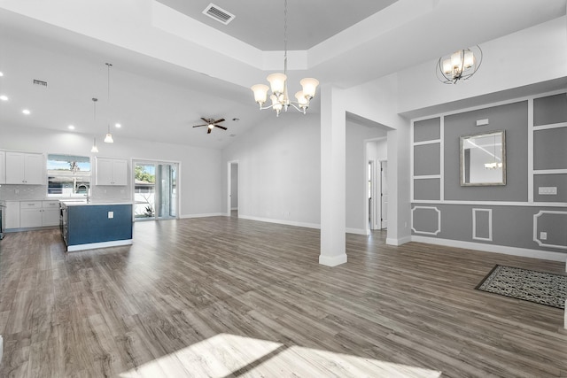 unfurnished living room featuring dark wood finished floors, baseboards, visible vents, and a sink