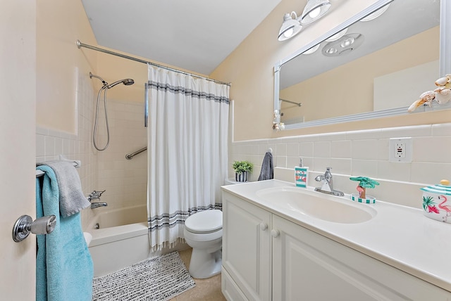 bathroom with vanity, a wainscoted wall, shower / bath combo, tile walls, and toilet