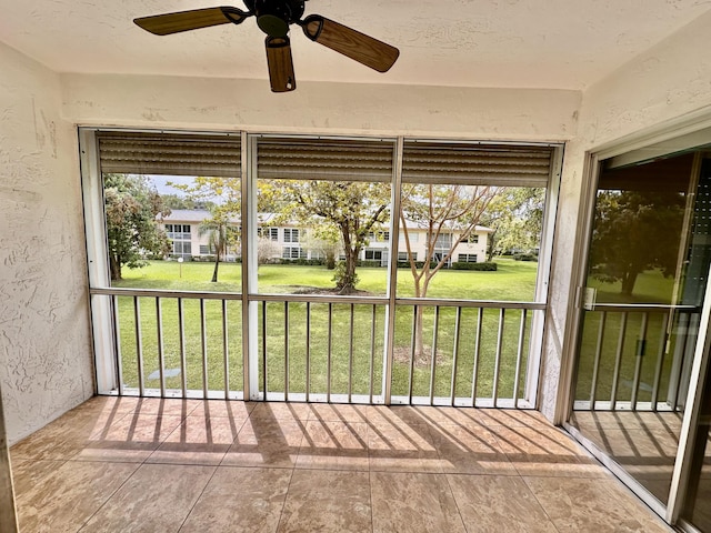 unfurnished sunroom with a residential view and a healthy amount of sunlight