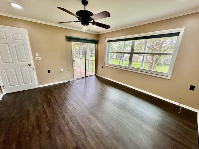 empty room with a ceiling fan, baseboards, dark wood-style flooring, and ornamental molding