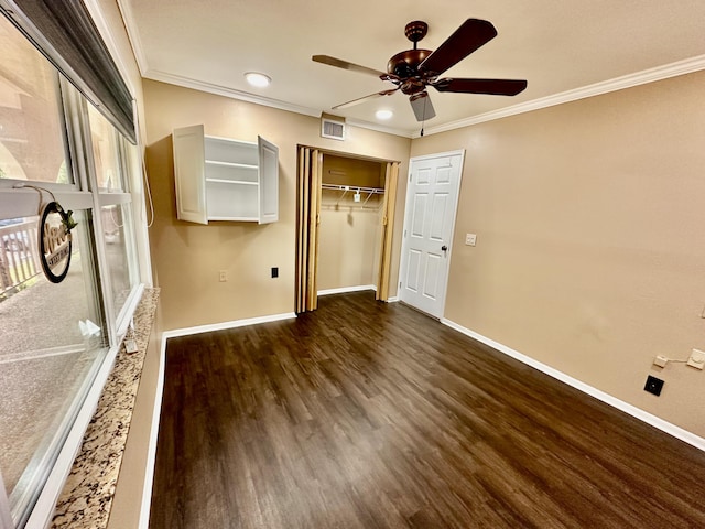 unfurnished bedroom featuring visible vents, baseboards, ornamental molding, and dark wood finished floors