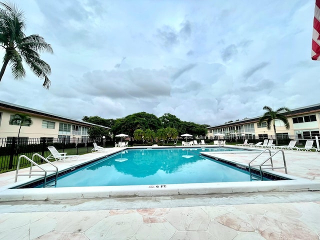 pool featuring a patio and fence