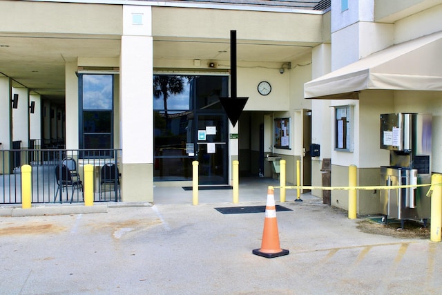 property entrance featuring stucco siding