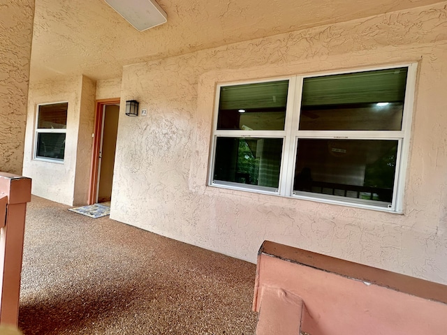 entrance to property with stucco siding