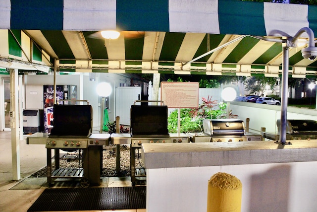 exterior space with outdoor wet bar, a grill, and exterior kitchen