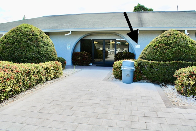 doorway to property with stucco siding