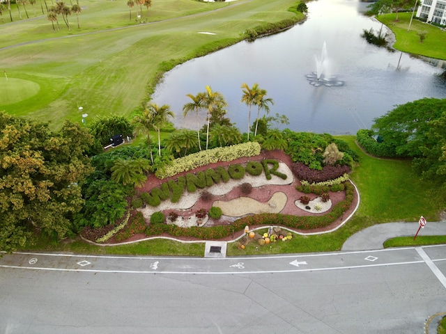 birds eye view of property featuring golf course view and a water view