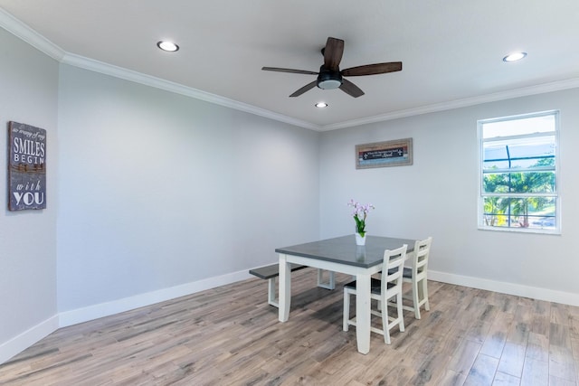 dining space featuring baseboards and crown molding