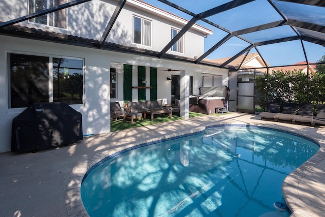 outdoor pool featuring ceiling fan, glass enclosure, outdoor lounge area, a patio area, and area for grilling