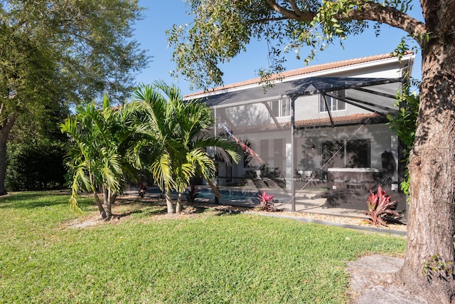 view of yard with glass enclosure, an outdoor pool, and a patio