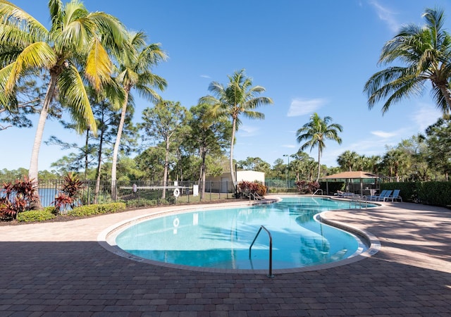 community pool featuring a patio and fence