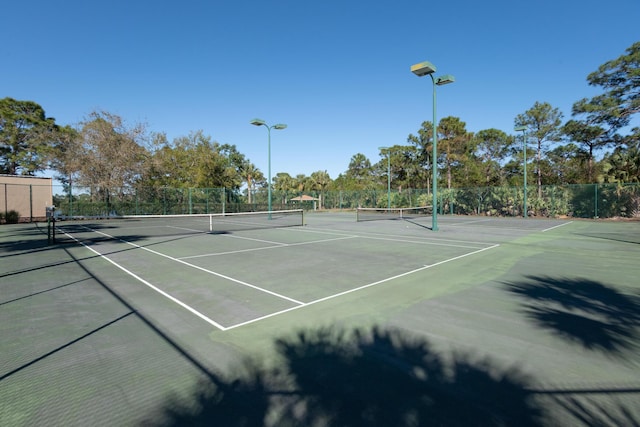 view of sport court featuring fence