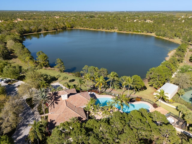 aerial view featuring a forest view and a water view