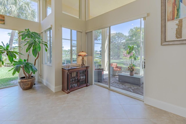 2488 SW Longwood Dr, Palm City, FL 34990 - interior space with baseboards, tile patterned flooring, and a towering ceiling