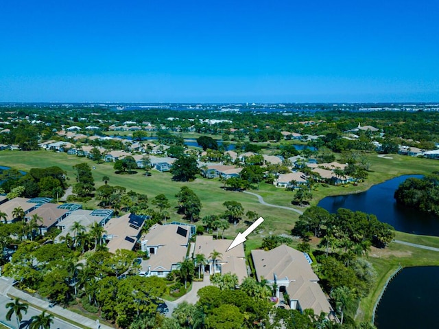 drone / aerial view featuring a residential view, golf course view, and a water view