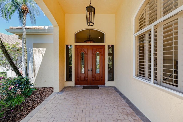 doorway to property with stucco siding