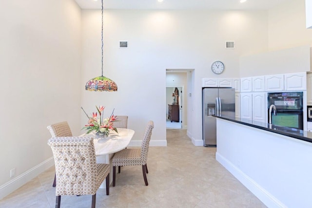 2488 SW Longwood Dr, Palm City, FL 34990 - dining space featuring recessed lighting, baseboards, and a towering ceiling