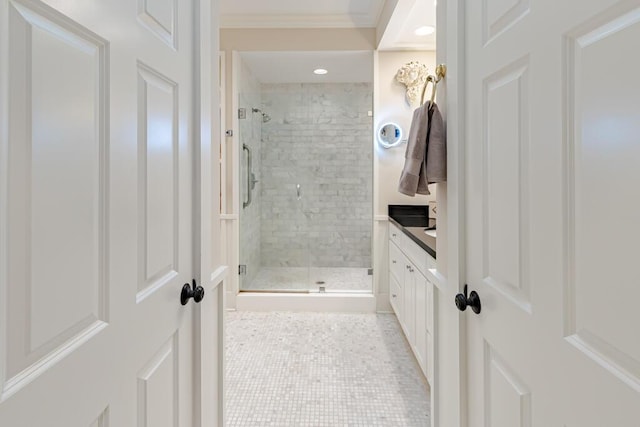 full bathroom with tile patterned flooring, a shower stall, vanity, and ornamental molding