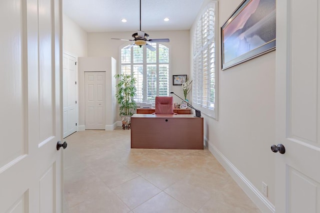 office featuring light tile patterned floors, recessed lighting, ceiling fan, and baseboards