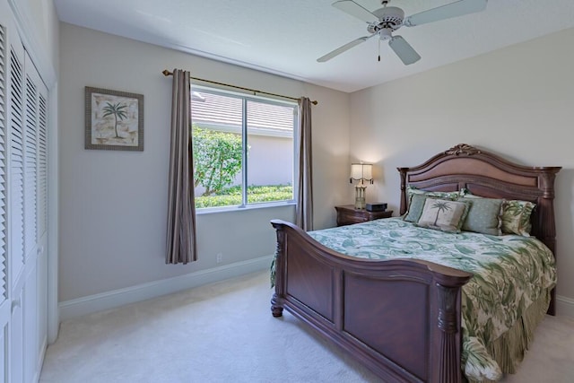 bedroom with baseboards, light colored carpet, and a ceiling fan