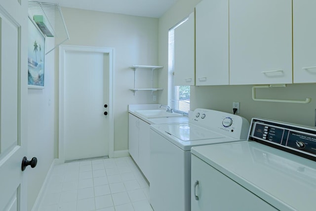 clothes washing area featuring baseboards, light tile patterned flooring, cabinet space, a sink, and independent washer and dryer