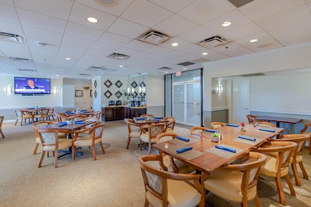 dining area featuring visible vents and light carpet