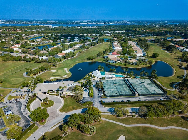 drone / aerial view with view of golf course and a water view