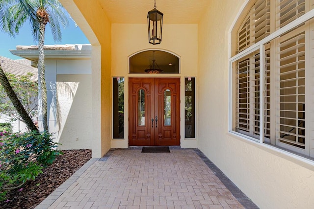 2488 SW Longwood Dr, Palm City, FL 34990 - doorway to property featuring stucco siding