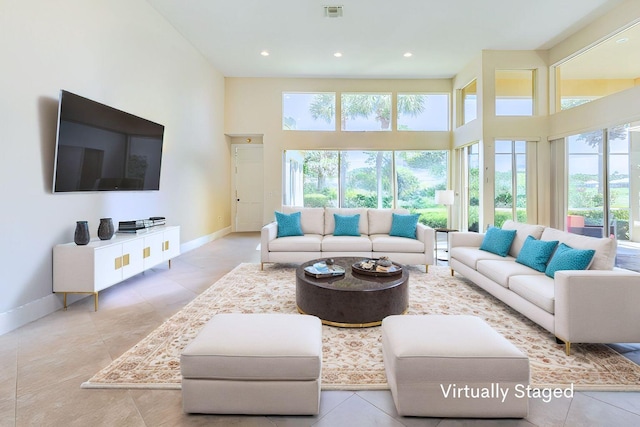 2488 SW Longwood Dr, Palm City, FL 34990 - living area featuring baseboards, visible vents, plenty of natural light, and a high ceiling