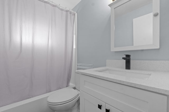 bathroom featuring toilet, vanity, and shower / bath combo with shower curtain