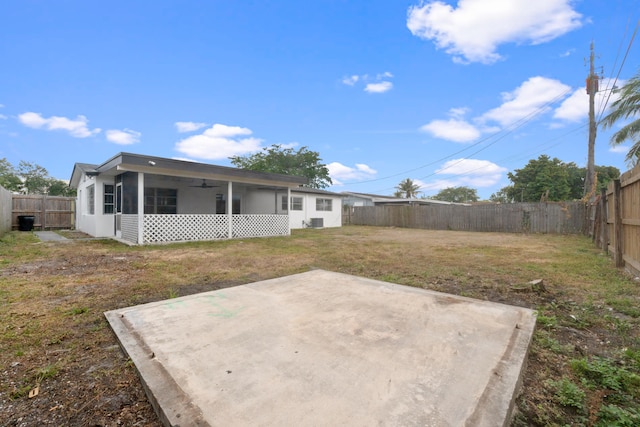 back of property featuring a ceiling fan, a patio area, and a sunroom