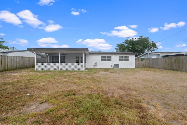 rear view of property featuring a sunroom, central AC unit, and a ceiling fan