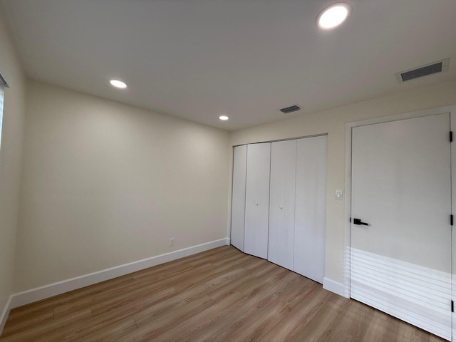 unfurnished bedroom featuring recessed lighting, visible vents, and wood finished floors