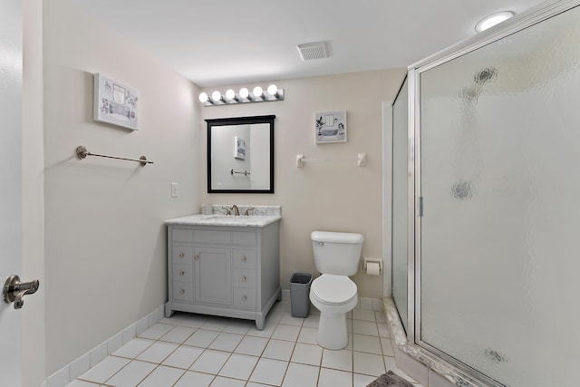 bathroom with visible vents, toilet, a stall shower, tile patterned flooring, and vanity