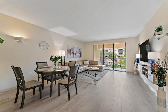 dining room with light wood-style flooring and baseboards