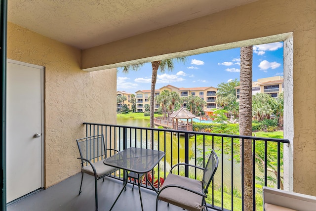 balcony with a water view and a residential view