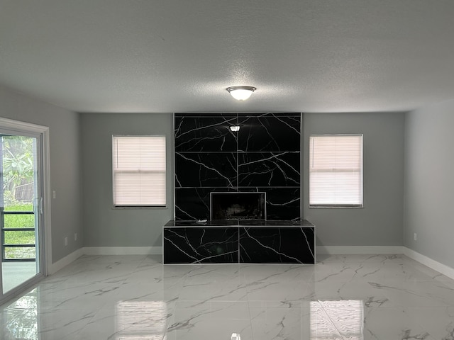 room details with a fireplace, baseboards, and a textured ceiling