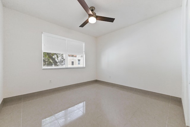 unfurnished room featuring light tile patterned floors and a ceiling fan