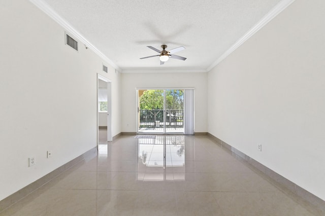 unfurnished room with tile patterned flooring, visible vents, crown molding, baseboards, and a textured ceiling