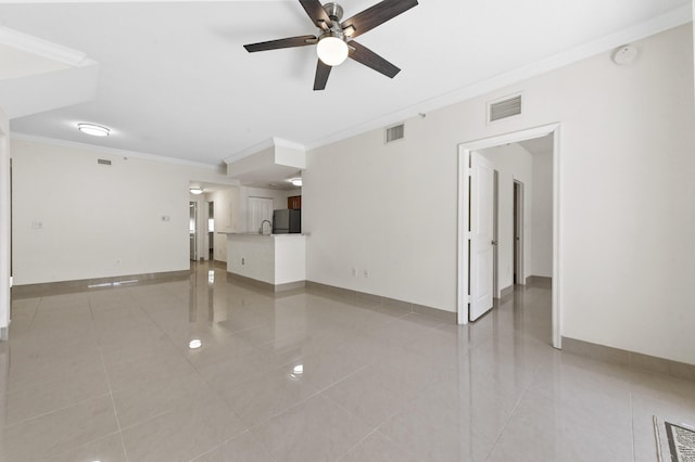 unfurnished living room featuring visible vents, baseboards, and crown molding