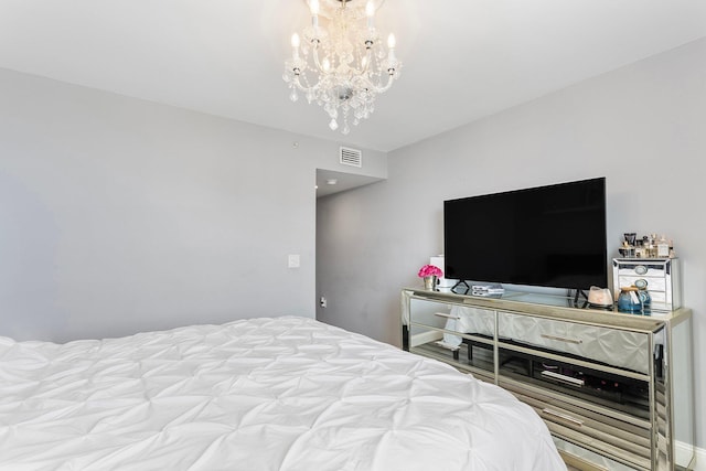 bedroom with visible vents and a chandelier