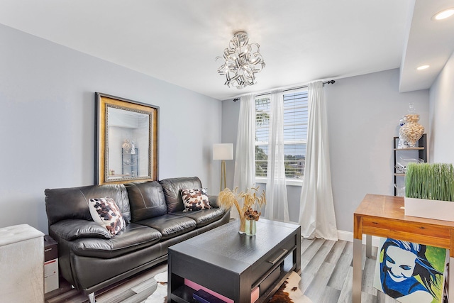 living room with recessed lighting, baseboards, a chandelier, and light wood finished floors