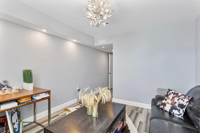 living room with wood finished floors, visible vents, baseboards, an inviting chandelier, and recessed lighting