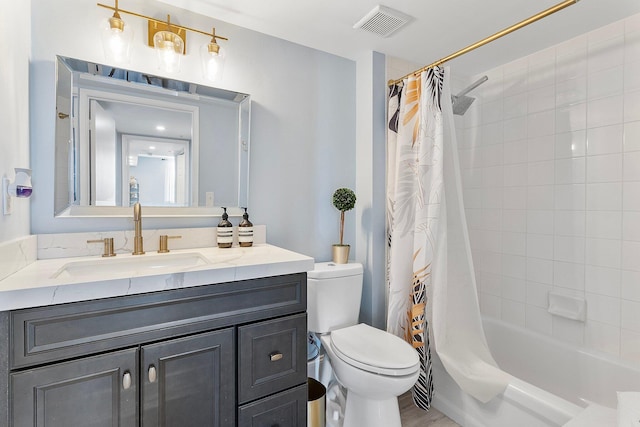 full bathroom with visible vents, toilet, vanity, and shower / tub combo with curtain