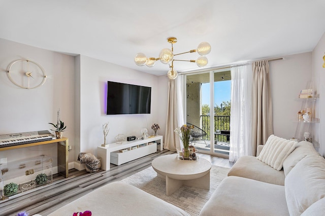 living area with a notable chandelier and wood finished floors