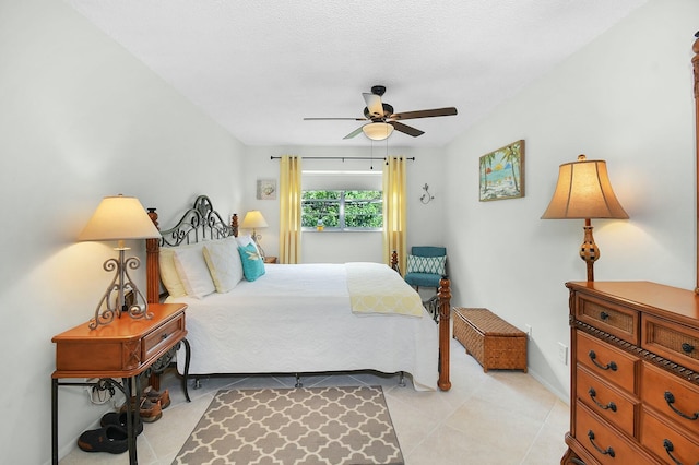 bedroom with light tile patterned floors, a ceiling fan, and baseboards