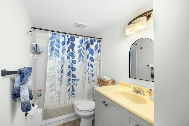 full bathroom featuring visible vents, shower / bath combo with shower curtain, toilet, and vanity