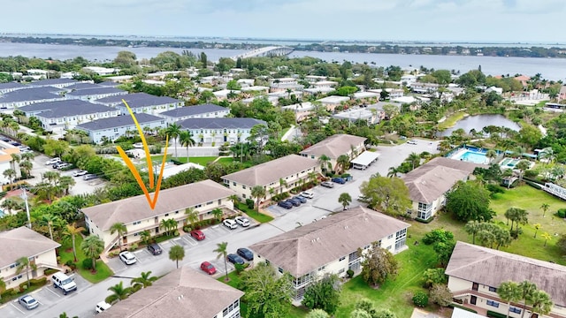 drone / aerial view featuring a residential view and a water view